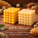 100% natural beeswax candles shaped like honeycomb, with honey dipper and flowers, showcasing raw honey purity